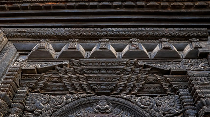 Wood carvings of Hindu Gods on the temple in Bhaktapur Durbar Square