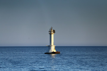 white lighthouse in the sea