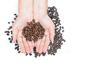 Hand holding coffee beans on white background.