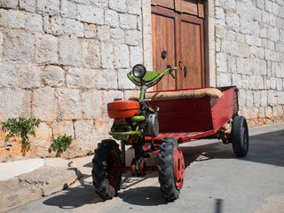 Old small tractor on stone streets of island Vis in Croatia