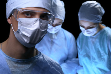 Medical team performing operation. Focus at female doctor 