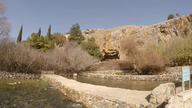 Tourists visit archaeological site of cave of Greek god pan, in Hermon Stream Nature Reserve, also known as Banyas, Golan, Israel