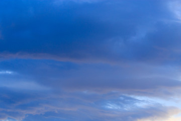 Clouds after rain before sunset as a background