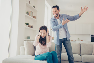 Portrait of stylish trendy couple having big drunk fight misunde