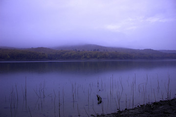  Rest on the shore of the reservoir. Beautiful water landscape in nature in the forest. Calm lake on a fall day. Colorful landscape on the lake in autumn. Camping by the lake. 