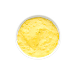 Tasty yellow sauce in bowl on white background