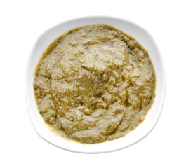 Tasty basil sauce in bowl on white background