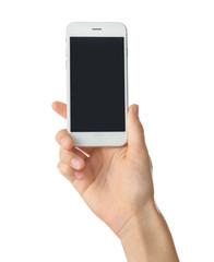 Young woman holding mobile phone on white background
