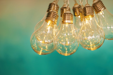 Glowing light bulbs on color background