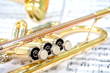 Still life. Two golden trumpets lie on notes. Brass duet. Jazz band.