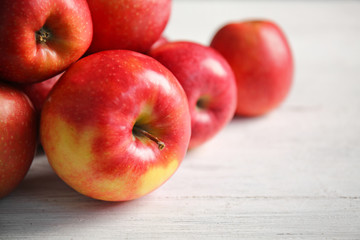 Ripe tasty apples on wooden table