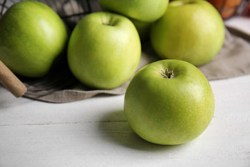 Ripe tasty apples on wooden table