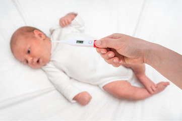 Measuring temperature to a newborn baby with digital thermometer