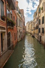 Fototapeta na wymiar VENICE, ITALY- OCTOBER 30, 2018: Traditional narrow canal with gondolas in Venice, Italy