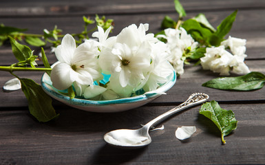 Obraz na płótnie Canvas White flowers of jasmine on wooden background.Arabian jasmine flowers