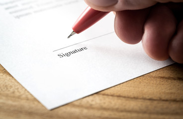 Writing signature. Man signing settlement, contract or agreement for employment and hiring,...