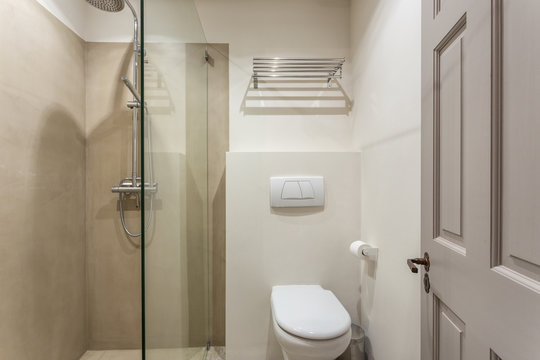 Modern bathroom shower room with toilet and amenities.