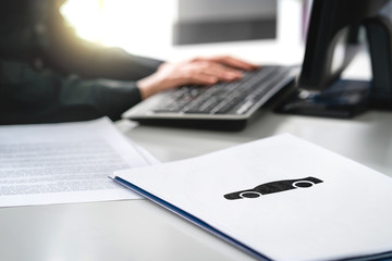 Woman writing car insurance document, bank loan application or lease contract. Car dealer working...