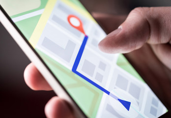 Map application in smartphone. Man navigating in city with mobile phone. Person using cellphone and...