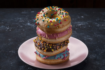 Donuts on a plate. Tasty colorful donuts.