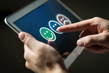 Man using tablet to give review, opinion and feedback to survey, poll or questionnaire for user...