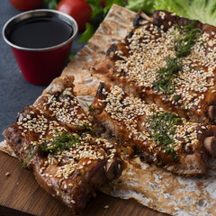 Roasted pork ribs with seasame and spicy sauce.  Closeup