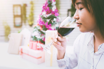 Young woman with a glass of red wine.