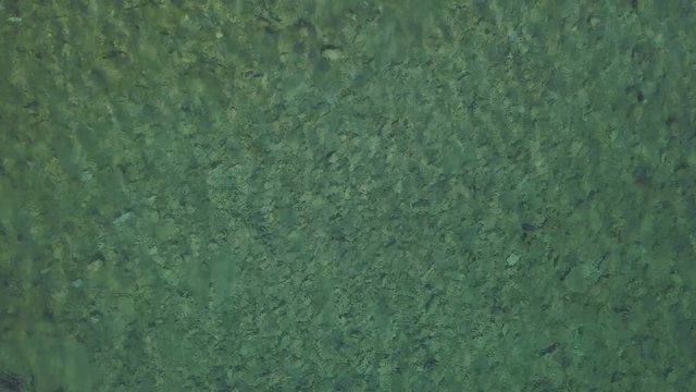 Aerial view of water reflections on the sea. Transparent water