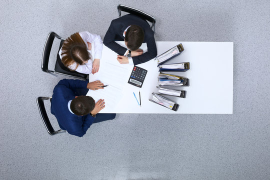Business people at meeting, view from  above. Bookkeeper or financial inspector  making report, calculating or checking balance