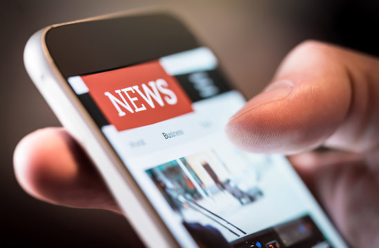 Online News In Mobile Phone. Close Up Of Smartphone Screen. Man Reading Articles In Application. Hand Holding Smart Device. Mockup Website. Newspaper And Portal On Internet.