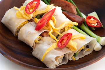 Thai Steamed Rice Noodle Rolls on wood background