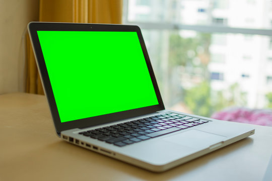 Laptop With Green Screen For Replacement With Blur Background