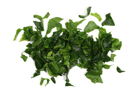 Fresh sliced, cut up spinach leaves isolated on white background, top view