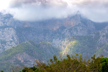 Rocky peaks of the Taurus Mountains during variable autumn weather, at the same time clouds and glimpses of the sun