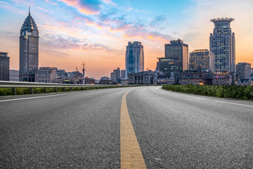 Obraz premium City skyscrapers and road asphalt pavement