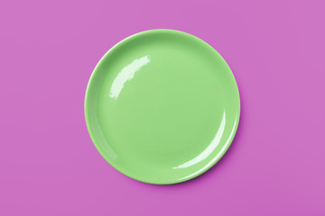Green pastel plate on complementary pink background.