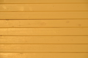 Fototapeta premium Yellow painted wooden house wall of timber 