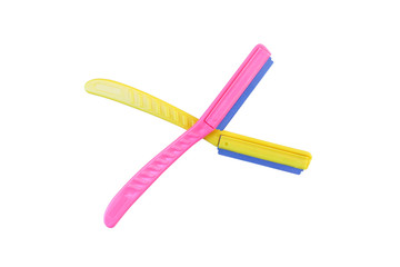 Pink and yellow plastic eyebrow razor makeup isolated on white background with clipping path