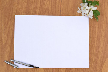 A clean sheet of paper on a wooden surface