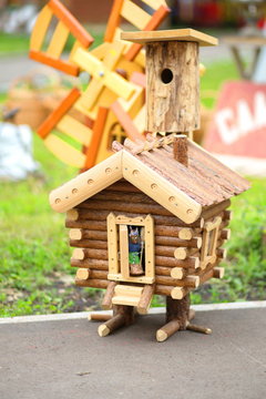 fabulous woman-yaga peeps out from the hut on chicken legs. Toys are sold on the street market.