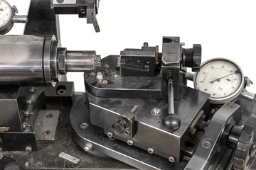 Manually operated lathe for making contact lenses.
