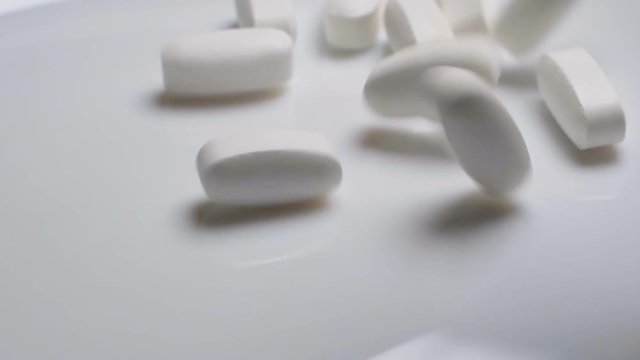 Falling pills. Medicine, sport supplement, creatine, hmb, bcaa, amino acid or vitamin pill.