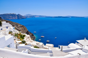 Panoramic aerial view of traditional white buildings and volcanic caldera at Oia, Santorini Island, Greece