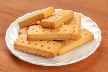 A closeup photo of Scottish shortbread butter cookies on a rustic wooden background