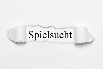 Fototapeta premium Spielsucht auf weißen gerissenen Papier