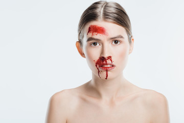 female victim of domestic violence with blood on face isolated on white