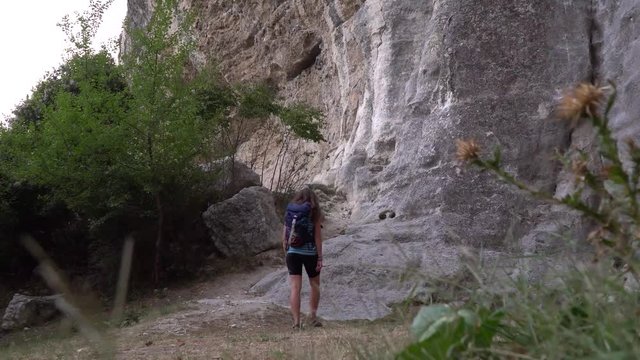 Girl climber walks in the mountains