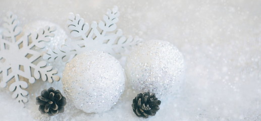 Fototapeta na wymiar Christmas background with toys and snow. Holiday background. Christmas balls and snowflake on abstract background.Christmas toys on white snowy.