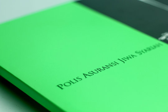 Insurance Policy Manual (Buku Polis Asuransi) Isolated on a White Background