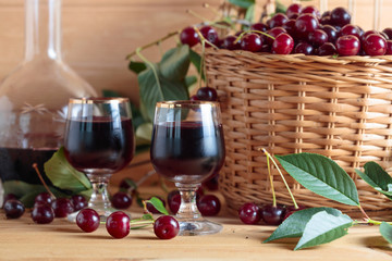 Cherry wine or liquor and ripe juicy cherries.